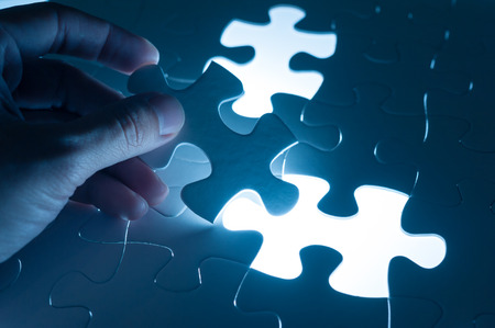 Hand insert jigsaw, conceptual image of business strategy, decision making conceptの写真素材
