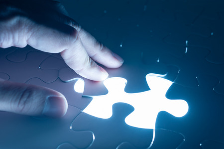 Hand insert jigsaw, conceptual image of business strategyの写真素材