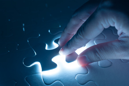 Hand insert jigsaw, conceptual image of business strategyの写真素材