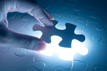 Hand insert jigsaw, conceptual image of business strategyの写真素材