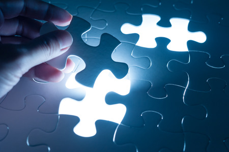 Hand insert jigsaw, conceptual image of business strategy, decision making conceptの写真素材