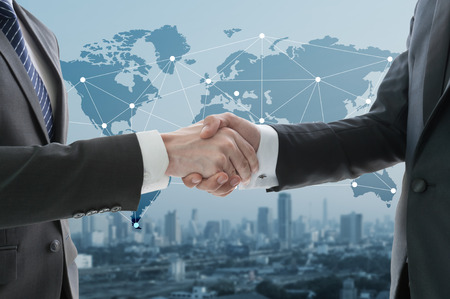 business hand shake with digital graph in background