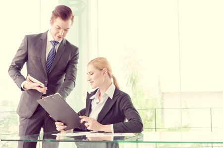 businessman and woman discussing in officeの写真素材