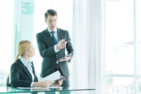 businessman and woman discussing in officeの写真素材