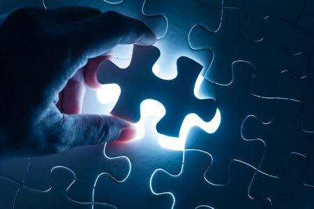 Hand insert jigsaw, conceptual image of business strategyの写真素材