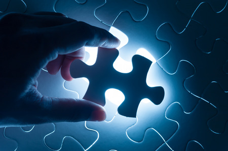 Hand insert jigsaw, conceptual image of business strategyの写真素材