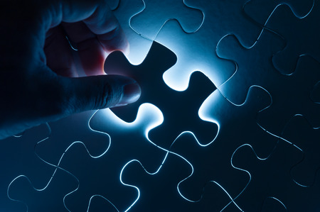 Hand insert jigsaw, conceptual image of business strategyの写真素材