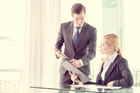 businessman and woman discussing in officeの写真素材