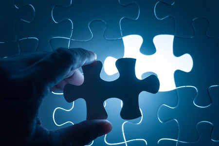 Hand insert jigsaw, conceptual image of business strategyの写真素材