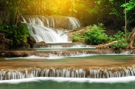 Deep forest waterfall in autumn scene at Huay Mae Kamin waterfall National Park Kanchanaburi Thailandの写真素材