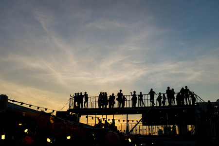 Silhouette of  people on upper floor with sunsetの写真素材