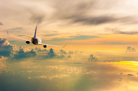 Airplane with background of cloudy sky at sunset or sunrise, exploration conceptual