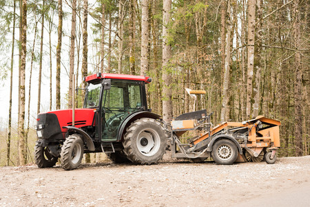Tractor parked with trees in backgroundの写真素材