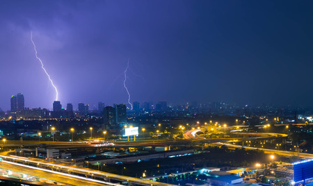 electric lightning strikes in city with high way road