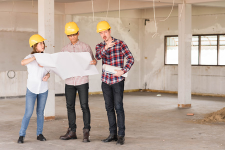 three construction engineers working together in side buiding planning for the renovationの写真素材