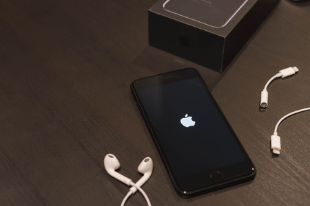 BANGKOK, THAILAND - NOVEMBER 24, 2016: Iphone7 Plus jet black serie with ear phone and jack converterのeditorial素材