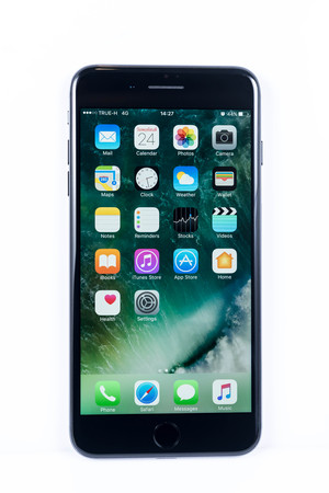 BANGKOK, THAILAND - NOVEMBER 20, 2016: Iphone7 Plus jet black series front view with default home scren on white plain floor, new generation of smartphone, smartphone without headphone jackのeditorial素材