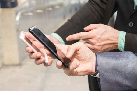 Two Westerner business man using smartphone