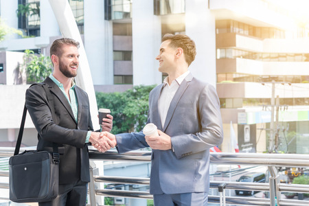 Two Westerner Business men shaking handsの写真素材