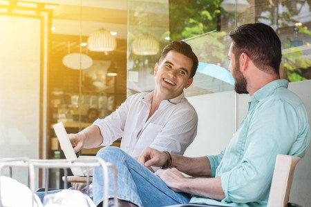 Two Westerner Business men working with laptop and smartphone togetherの写真素材