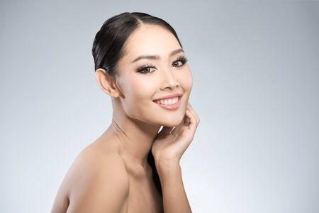 Beauty shot of young pretty asian woman with clear skin ongrey background, for skin ad and cosmetologyの写真素材