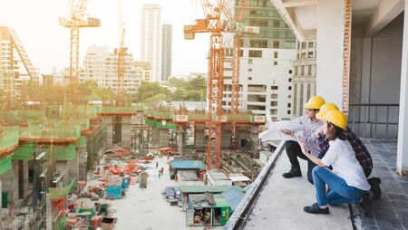 three construction engineers working together in construction site planning for the renovation