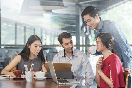 4 people meeting in coffee shop, business casual conceptualの写真素材