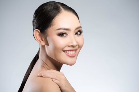 Beauty shot of young pretty asian woman with clear skin ongrey background, for skin ad and cosmetologyの写真素材
