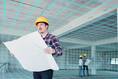 Three construction engineer discuss inside building, plan for renovation with 3d digital layoutの写真素材