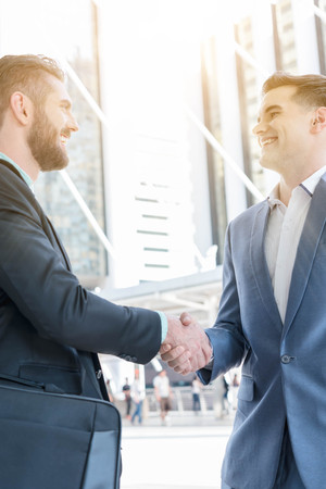 Hand shake of two businessman with sun flare, business conceptualの写真素材
