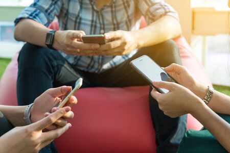 Hands of three person using smartphone together, IOT (internet of things conceptual)の写真素材
