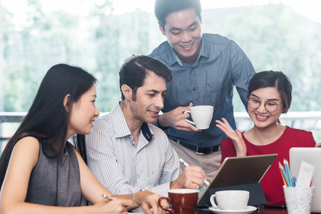4 people meeting in coffee shop, business casual conceptual
