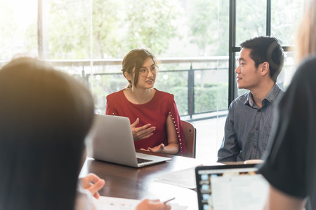 4 people meeting in coffee shop, business casual conceptualの写真素材