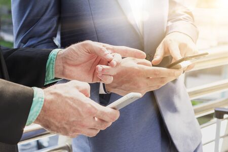 Two Westerner business man using smartphoneの写真素材