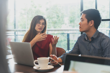 Two people meeting and discuss in coffee shop, freelance work style, outdoor business meetingの写真素材