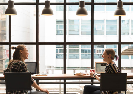 freelance working in coffee shop, Nomad worker conceptual, couple work together in cafe with laptopの写真素材