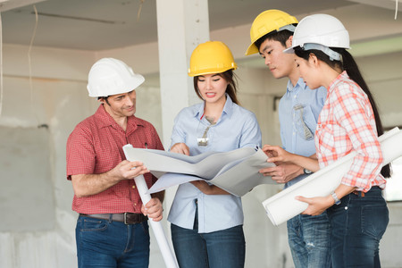 Four construction engineer working in side building plan for renovation, construction engineering conceptualの写真素材