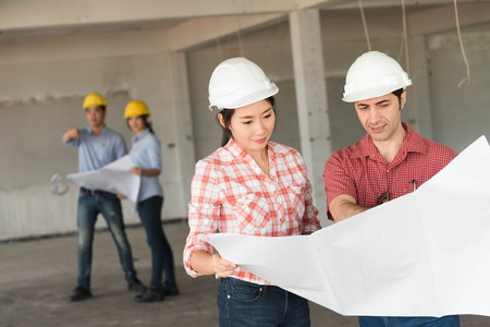 Four construction engineer working in side building plan for renovation, construction engineering conceptualの写真素材