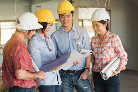 Four construction engineer working in side building plan for renovation, construction engineering conceptualの写真素材