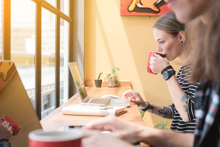Two freelance working in coffee shop, Nomad worker conceptual, couple work together in cafe with...