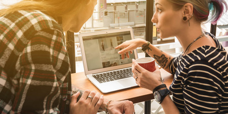 Two freelance working in coffee shop, Nomad worker conceptual, couple having fun work together in...