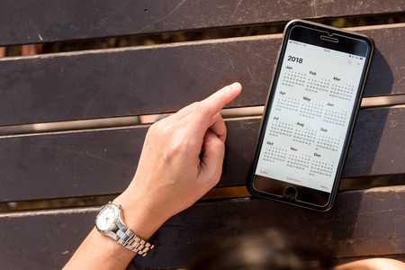 BANGKOK, THAILAND - NOVEMBER 26th, 2017: Hand of woman hold iphone 8 plus show calendar of 2018 on...