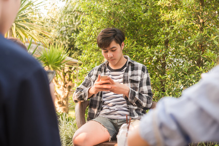 Group of six teenagers play social media in afternoonの写真素材
