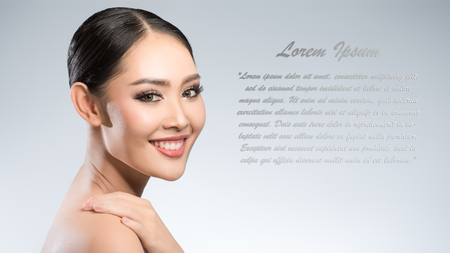 Beauty shot of young pretty asian woman with clear skin ongrey background, for skin ad and cosmetology with copy space for text insertionの写真素材