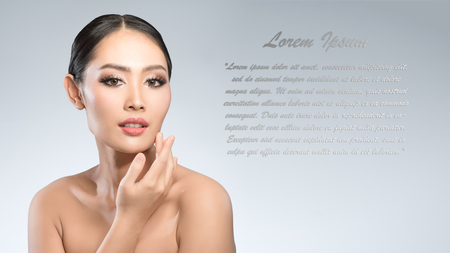 Beauty shot of young pretty asian woman with clear skin ongrey background, for skin ad and cosmetology with copy space for text insertionの写真素材
