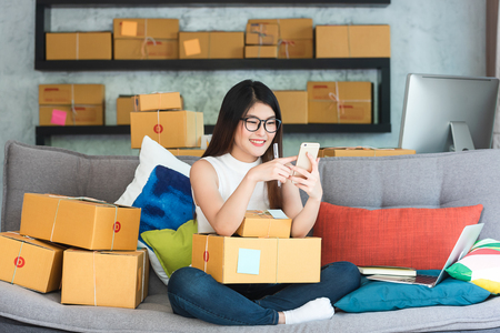 Young asian woman entrepreneur, teenager business owner work at home, alpha generation life style, online business conceptualの写真素材