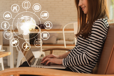 Beautiful young teenage woman freelance work with laptop at coffee shop, technology conceptual of IOT, internet of thingsの写真素材