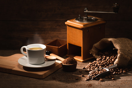 A shot of espresso with roasted coffee bean, grounded and old vintage coffee grinderの写真素材