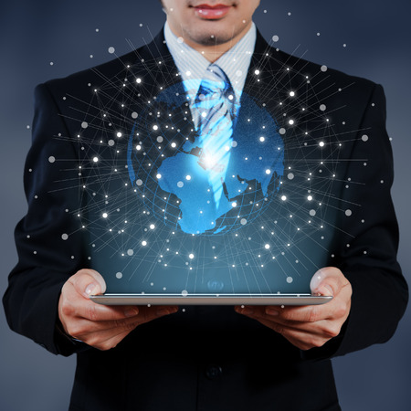 businessman use tablet with graphic effect of technology globalization conceptの写真素材