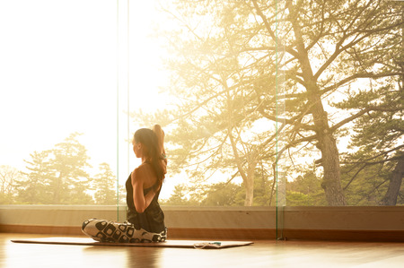 A yoga master practicing yoga streching back and shoulder muscleの写真素材